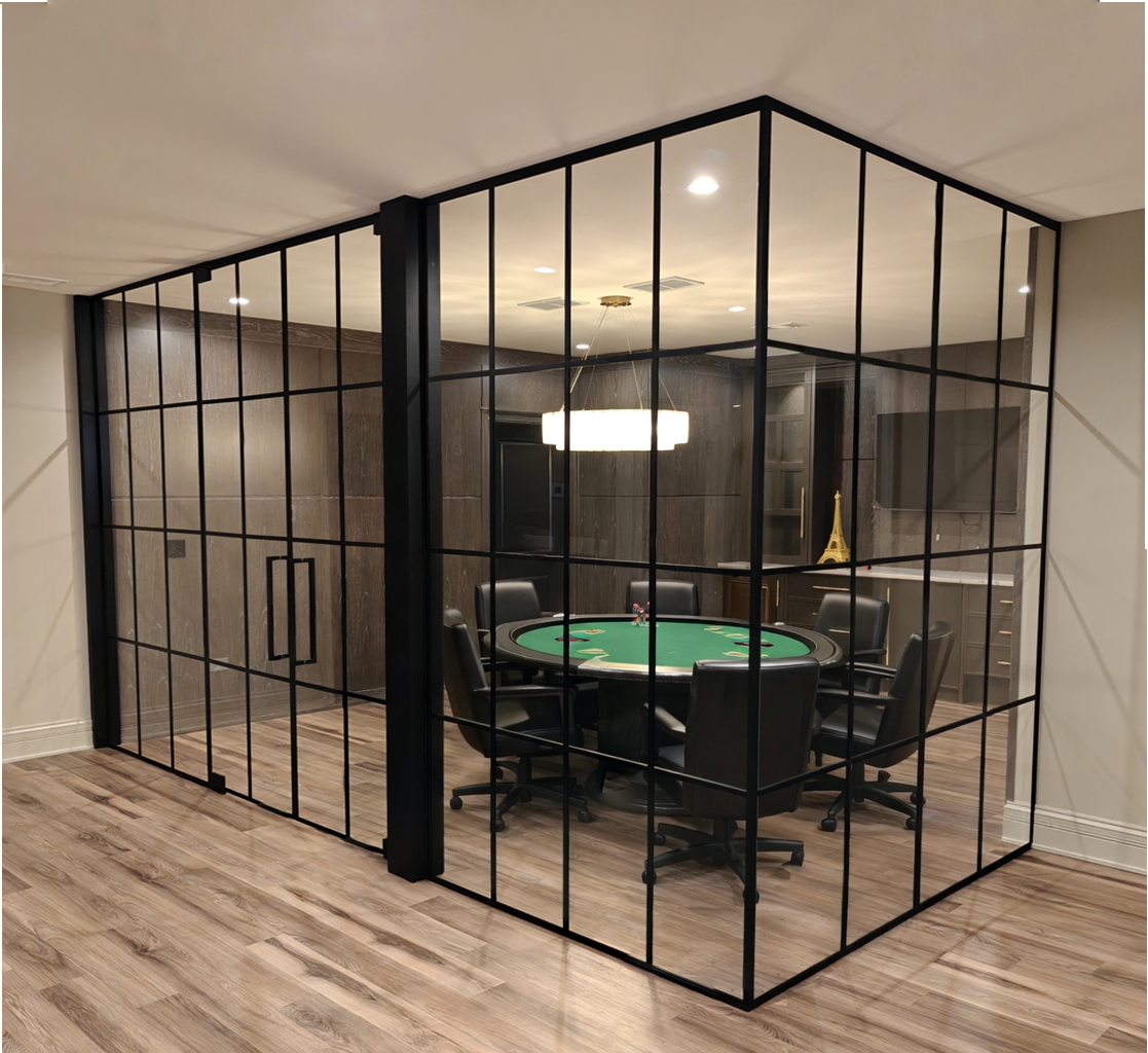 Black grid glass walls and double doors around a game room with a round poker table.