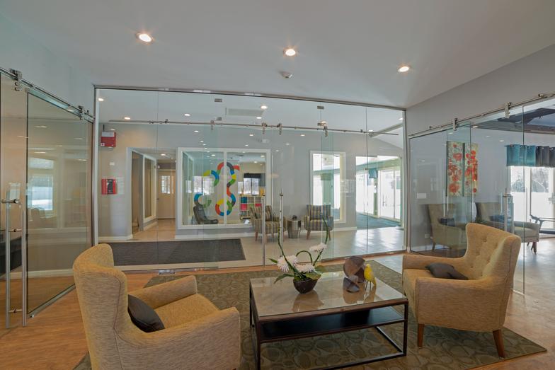 Another view of the glass meeting-room partitions and the adjacent office seating